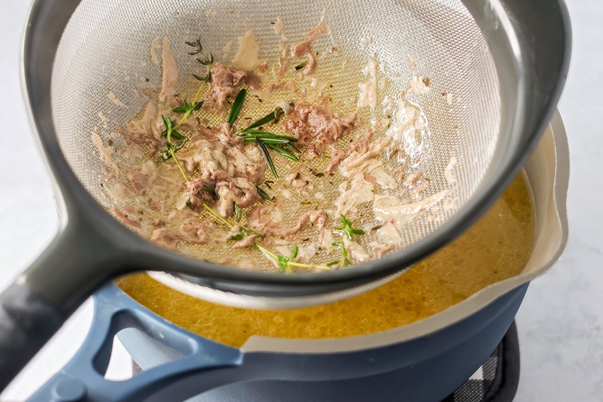 Straining the broth for turkey gravy.