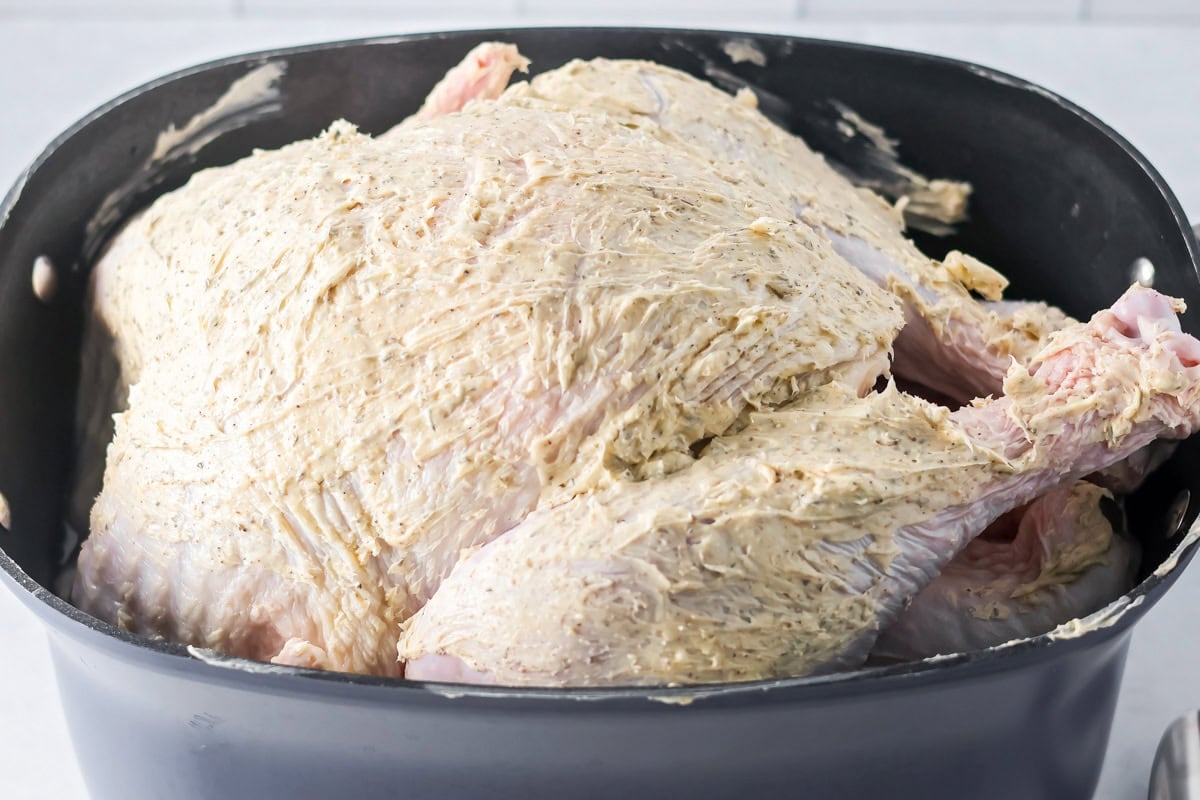 Rubbing butter on a turkey for crock pot turkey.