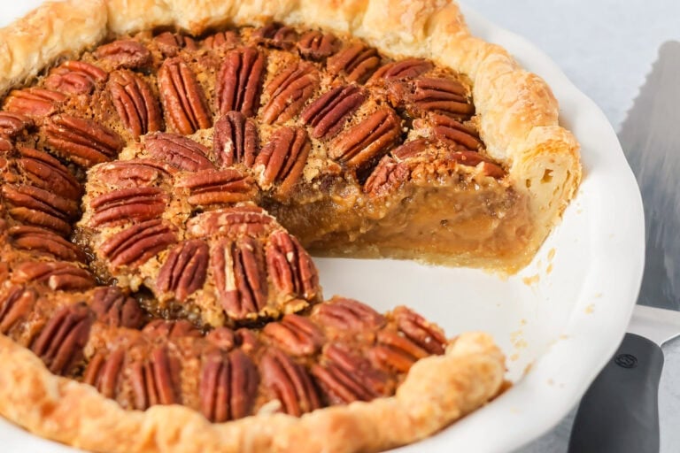 Custard pecan pie with a slice missing.