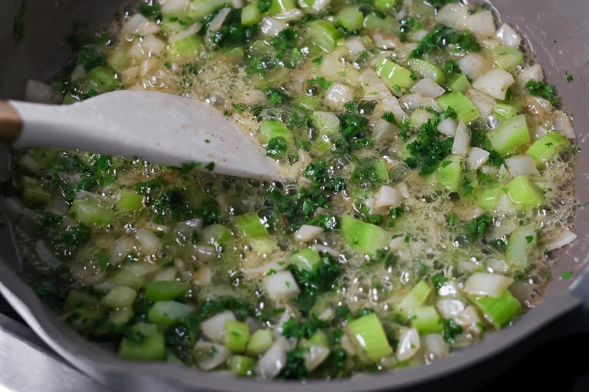Cooking veggies in a pan for make ahead stuffing.