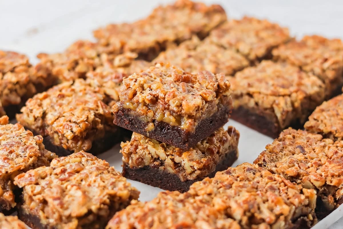 Sliced pecan pie brownies on a counter.