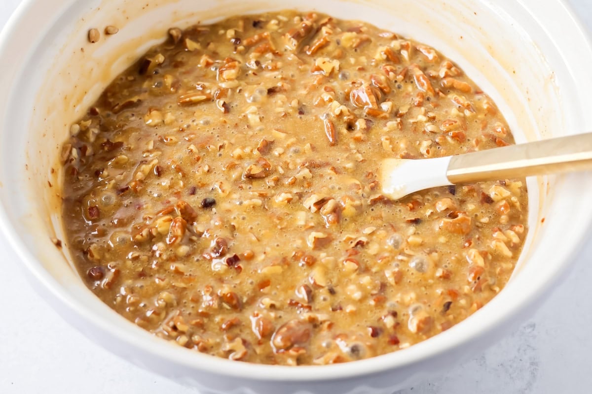 Pecan topping for pecan pie brownies mixed in a bowl.