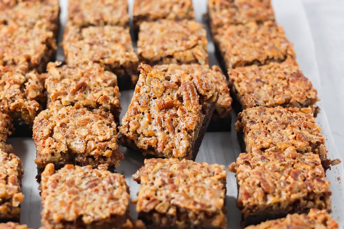 Sliced pecan pie brownies on a counter.