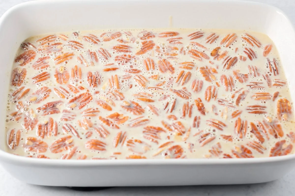 Pecan pie dump cake filling in a baking dish.