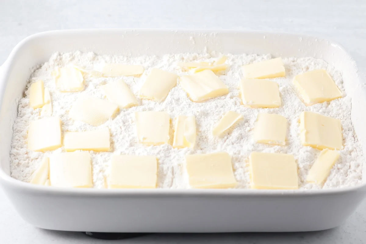 Cake mix and butter on top of a pecan pie dump cake.