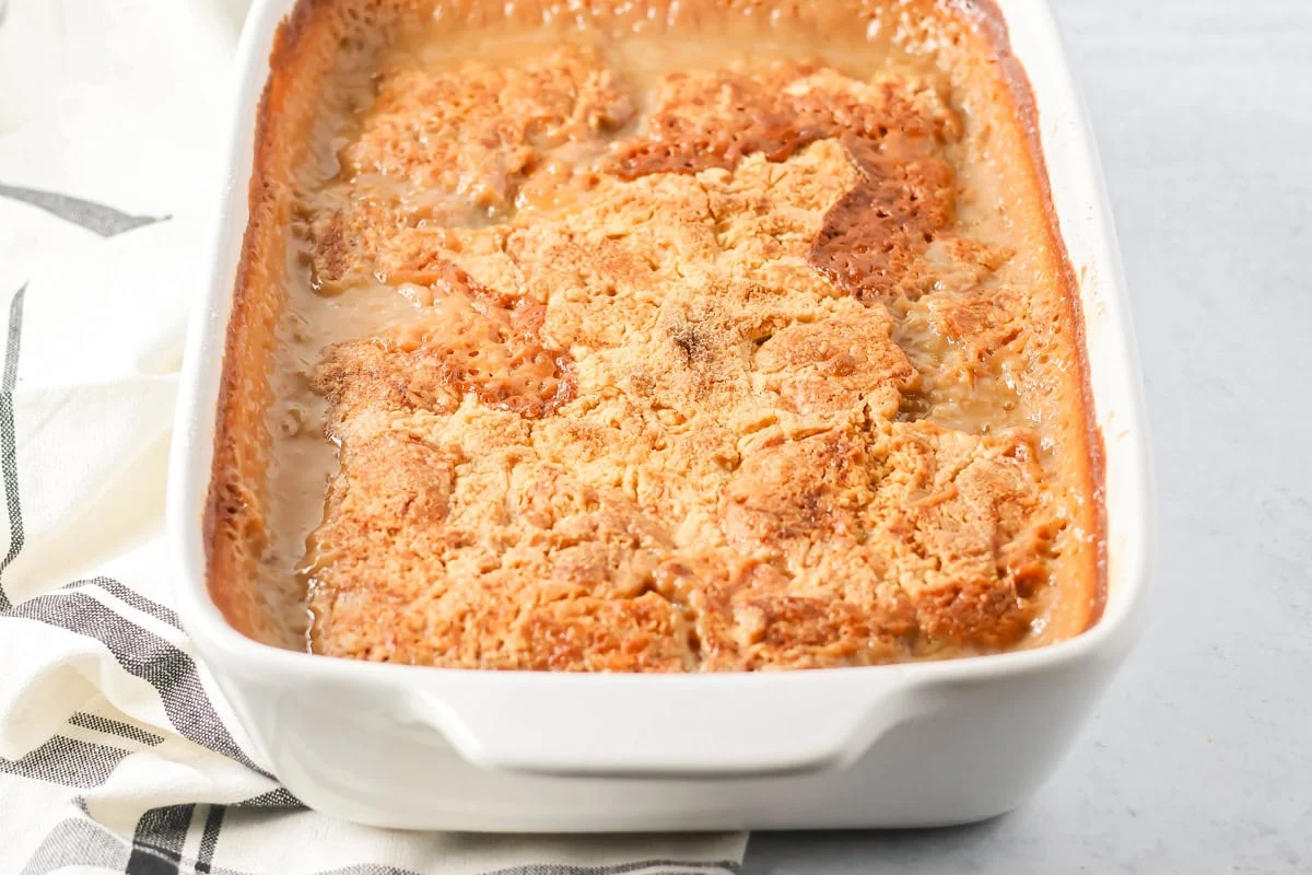 Baked pecan pie dump cake in a baking dish.