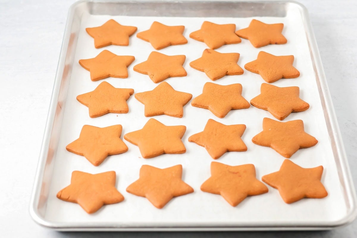 Star Pepparkaka cookies baked on a sheet pan.