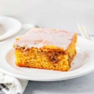 A slice of pumpkin honey bun cake on a white plate.