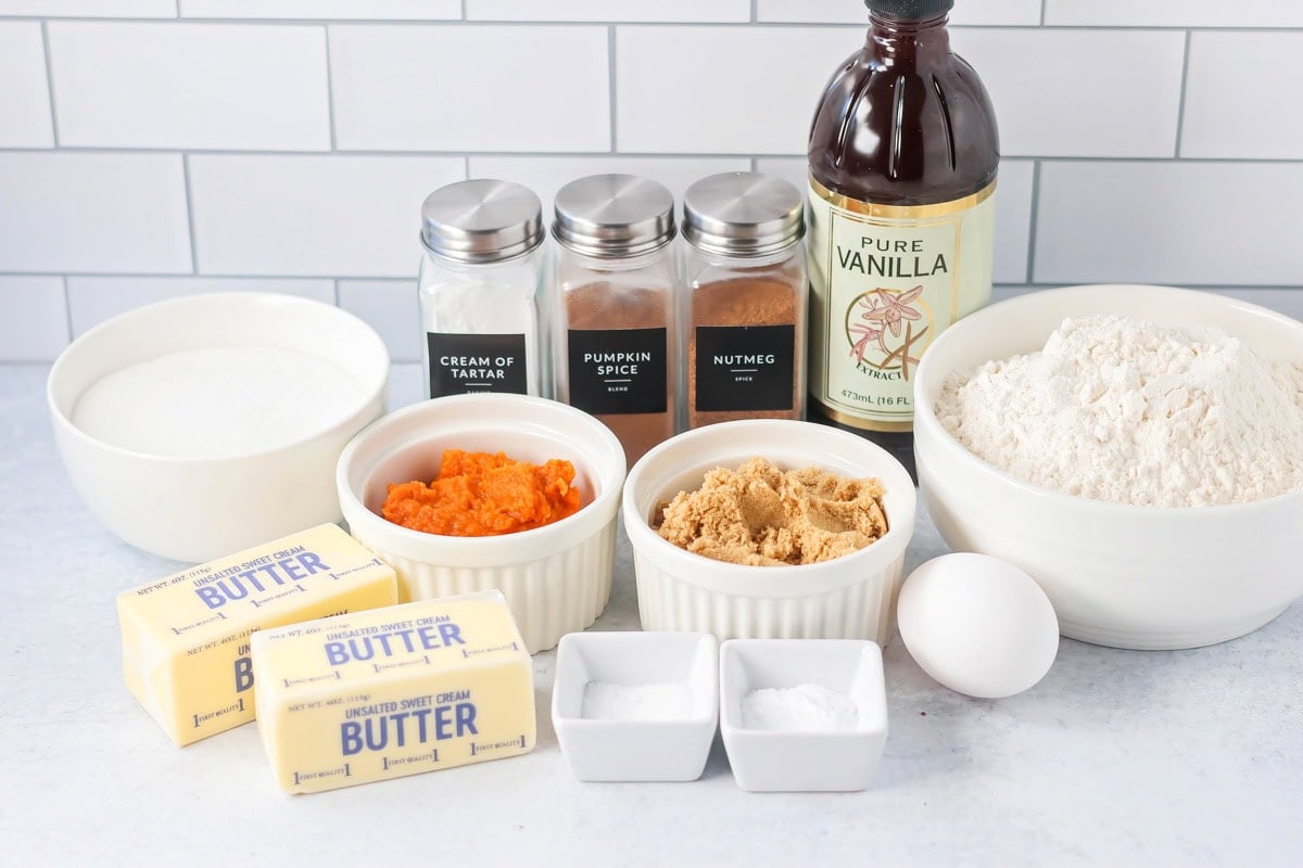 Ingredients for making pumpkin snickerdoodles on a kitchen counter.