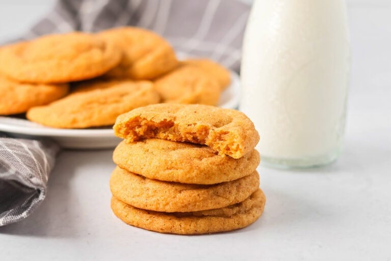 Pumpkin snickerdoodles stacked with a bit missing from the top one.