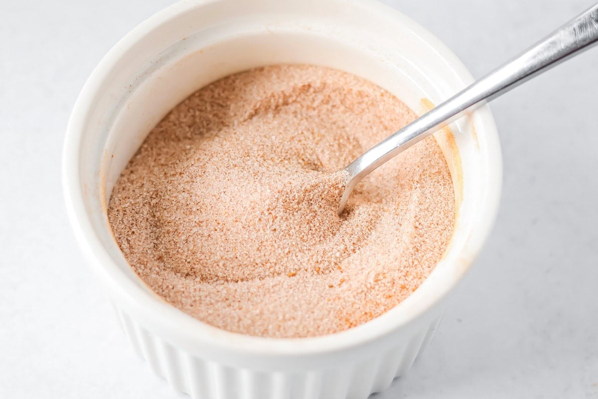 Cinnamon sugar mixture in a bowl for pumpkin snickerdoodles.