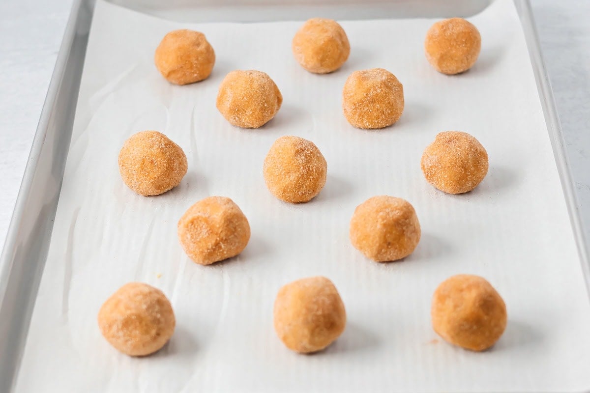 Pumpkin snickerdoodle balls on a sheet pan.
