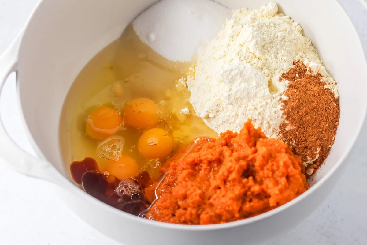 Ingredients for pumpkin tres leches cake in a bowl.