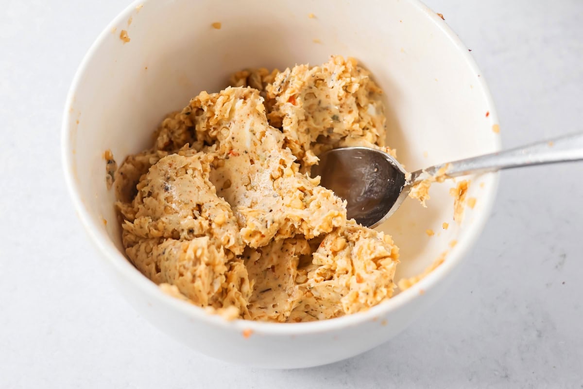 Mixing seasoning in a bowl for roast turkey breast.