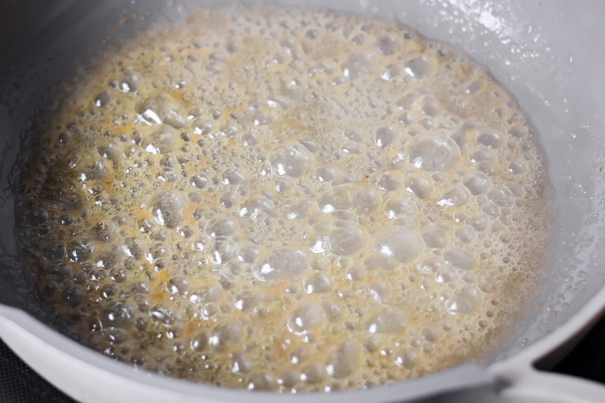 Butter bubbling in a pan for making roast turkey breast gravy.