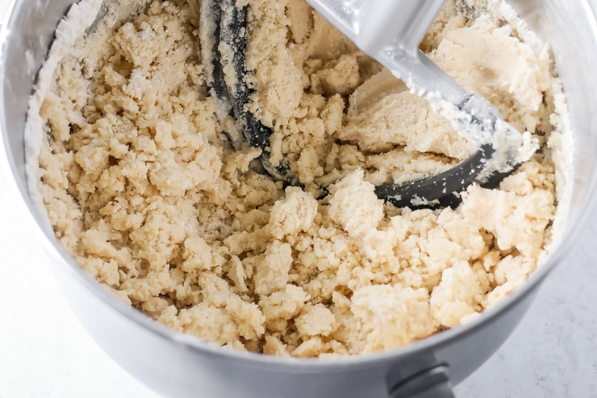 Mixing salted caramel cookie bars crust in a bowl.
