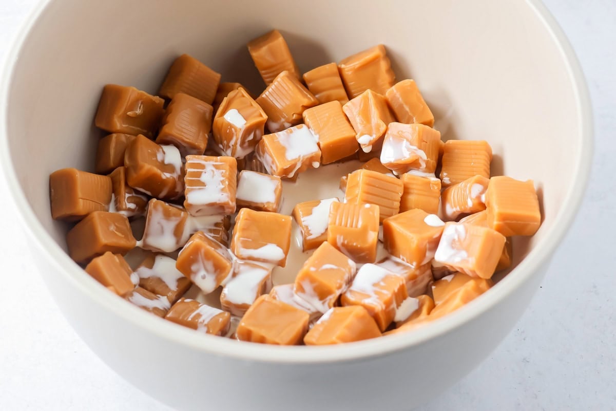 Caramel and cream in a bowl for making salted caramel cookie bars.