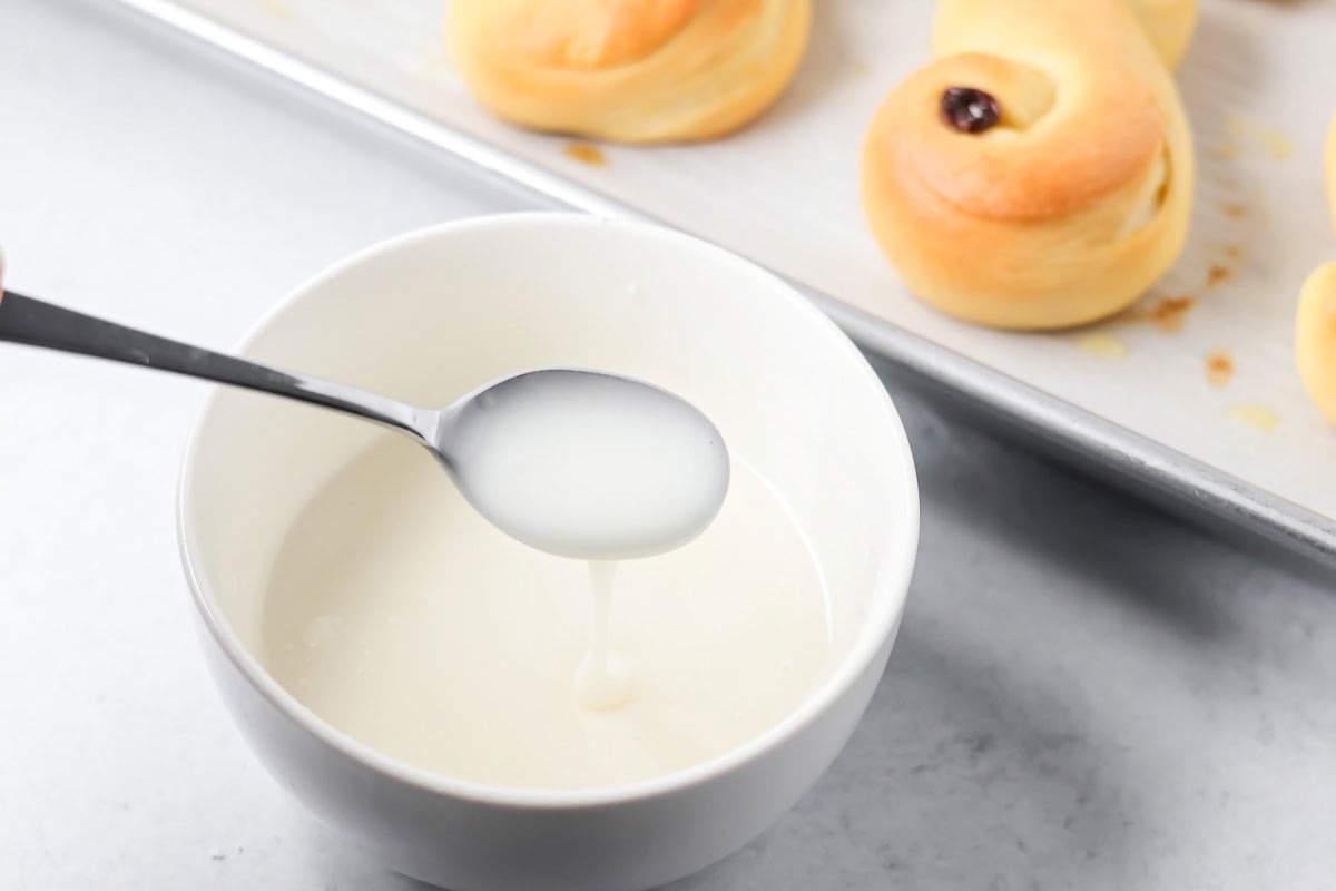 Glaze for St. Lucia Buns in a white bowl.