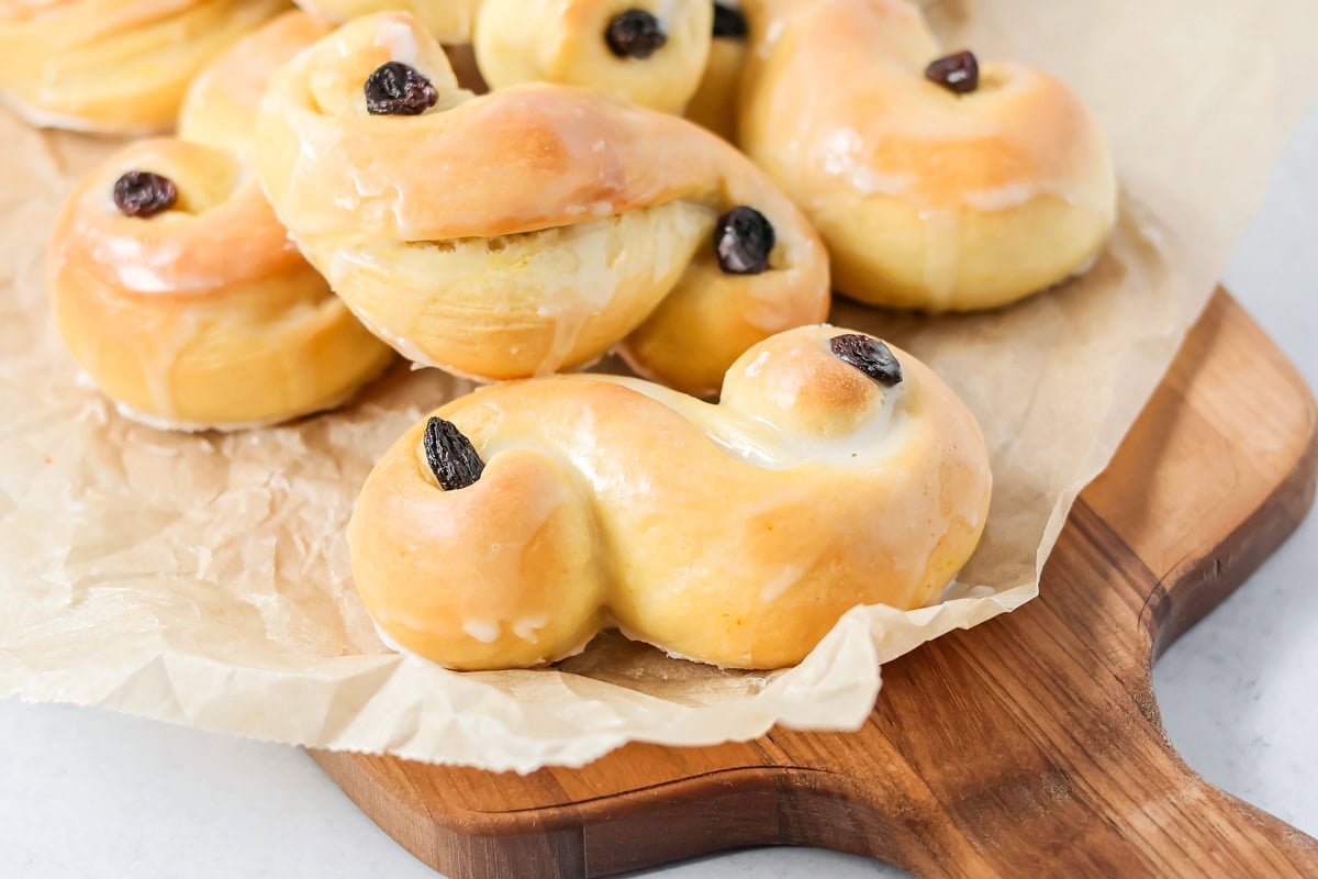 St. Lucia Buns glazed and served on a cutting board.