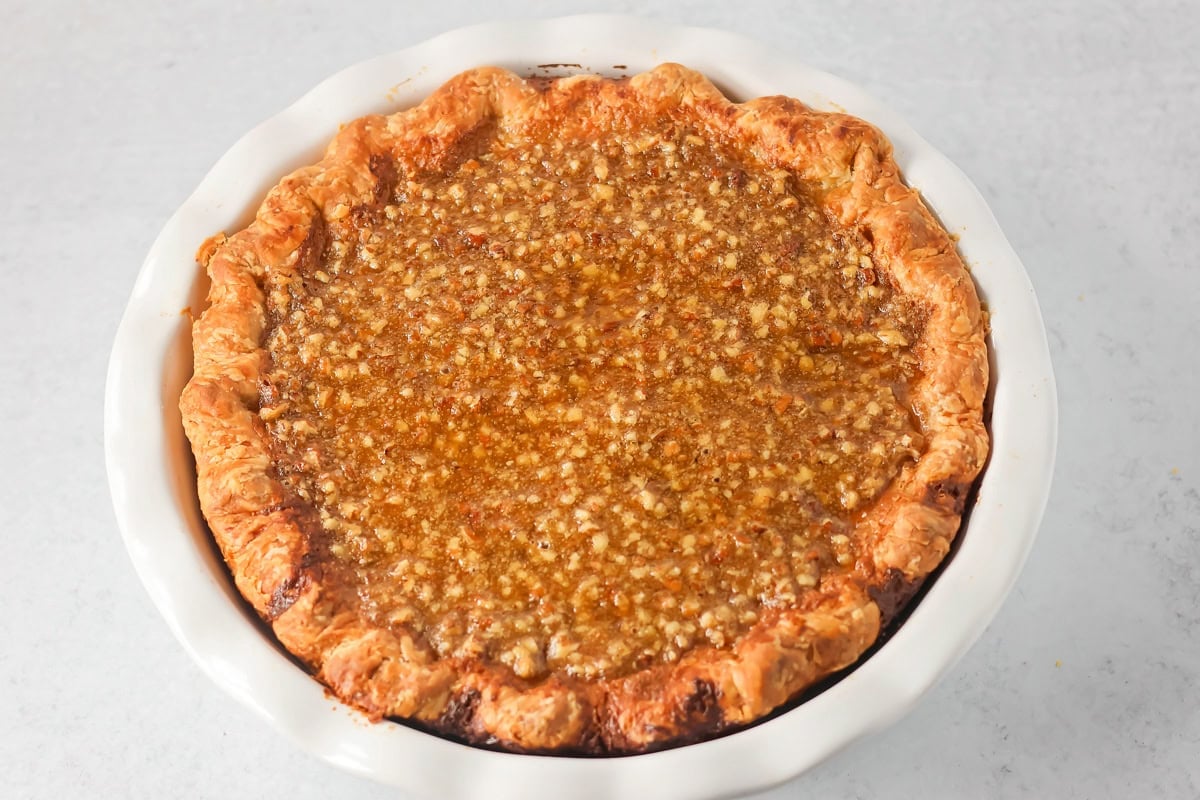 A baked sweet potato pecan pie in a baking dish.