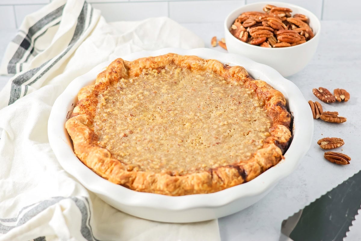A baked sweet potato pecan pie in a baking dish.