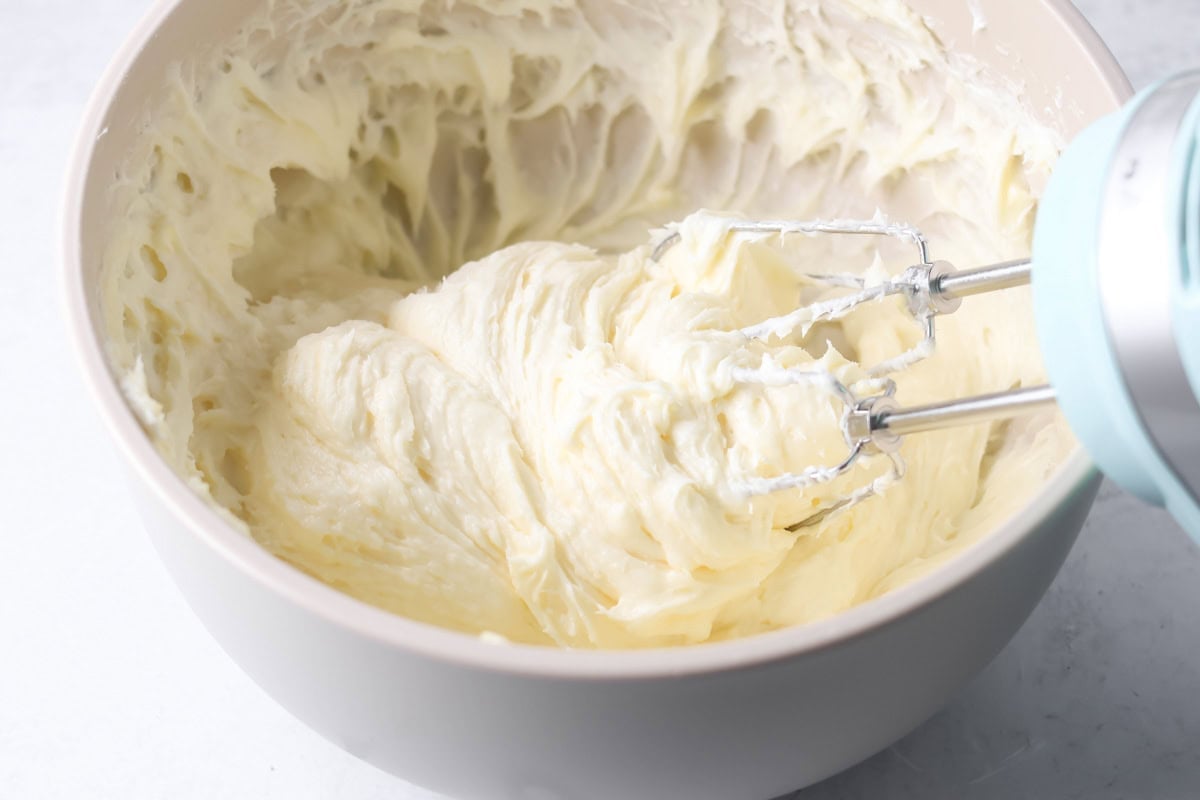 Mixing Christmas sugar cookie bars in a bowl.