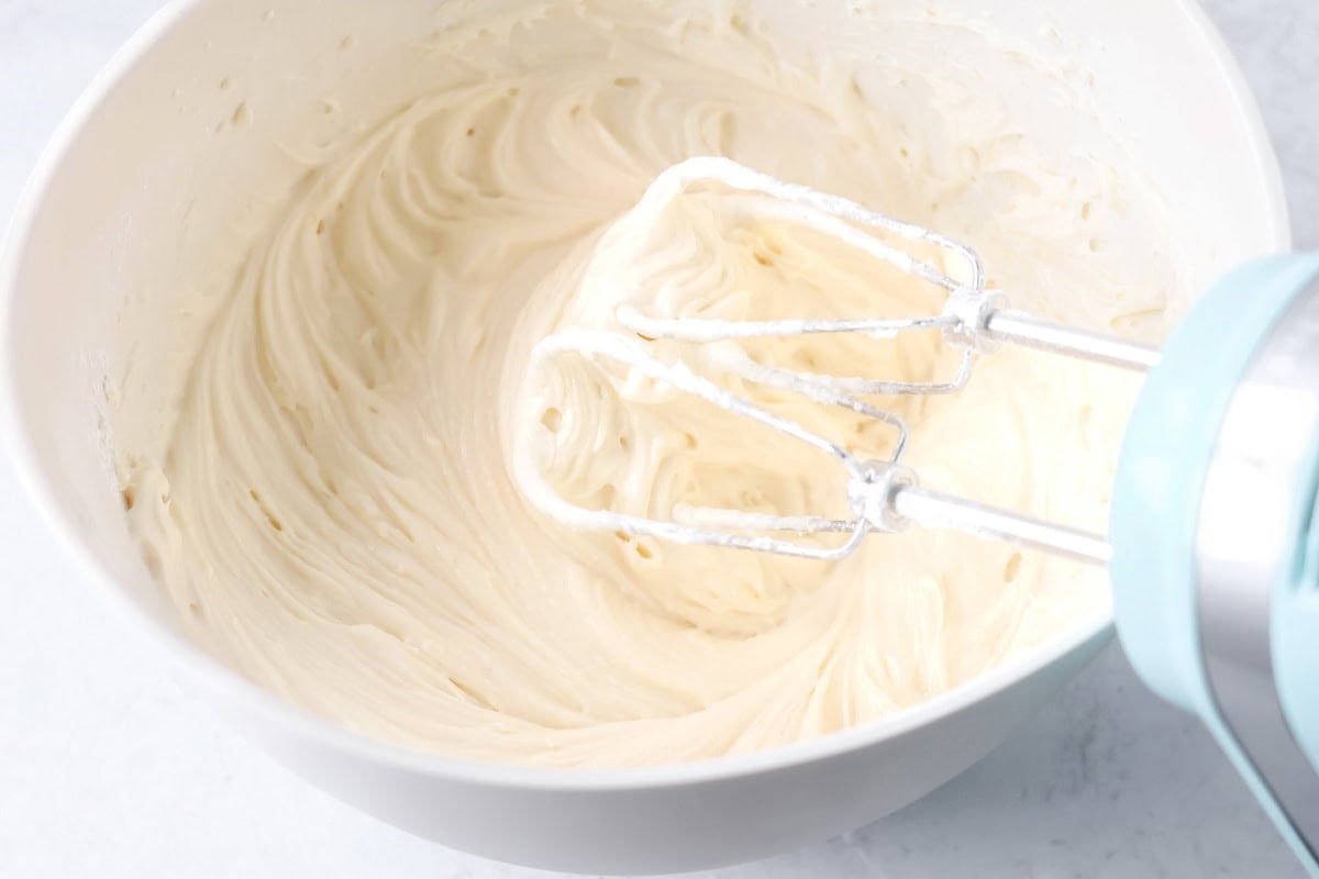Frosting for christmas sugar cookie bars in a bowl.