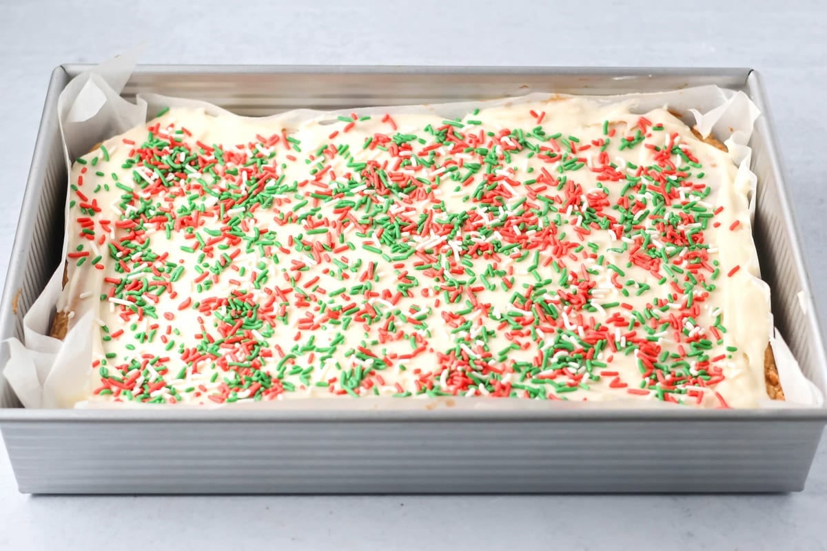 A pan of frosted Christmas sugar cookie bars.