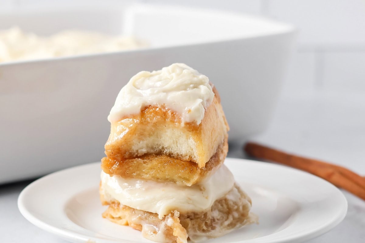 A stack of Hawaiian Roll cinnamon rolls on a white plate.