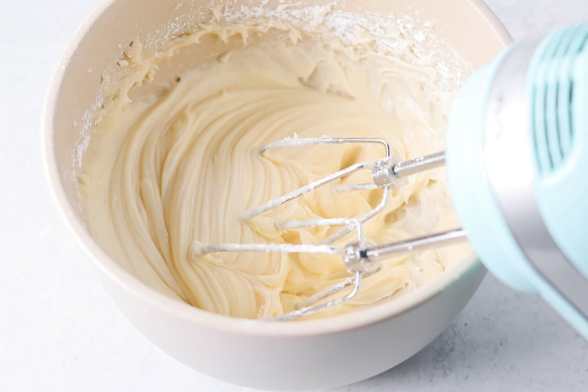 Frosting for Hawaiian king cinnamon rolls in a mixing bowl.
