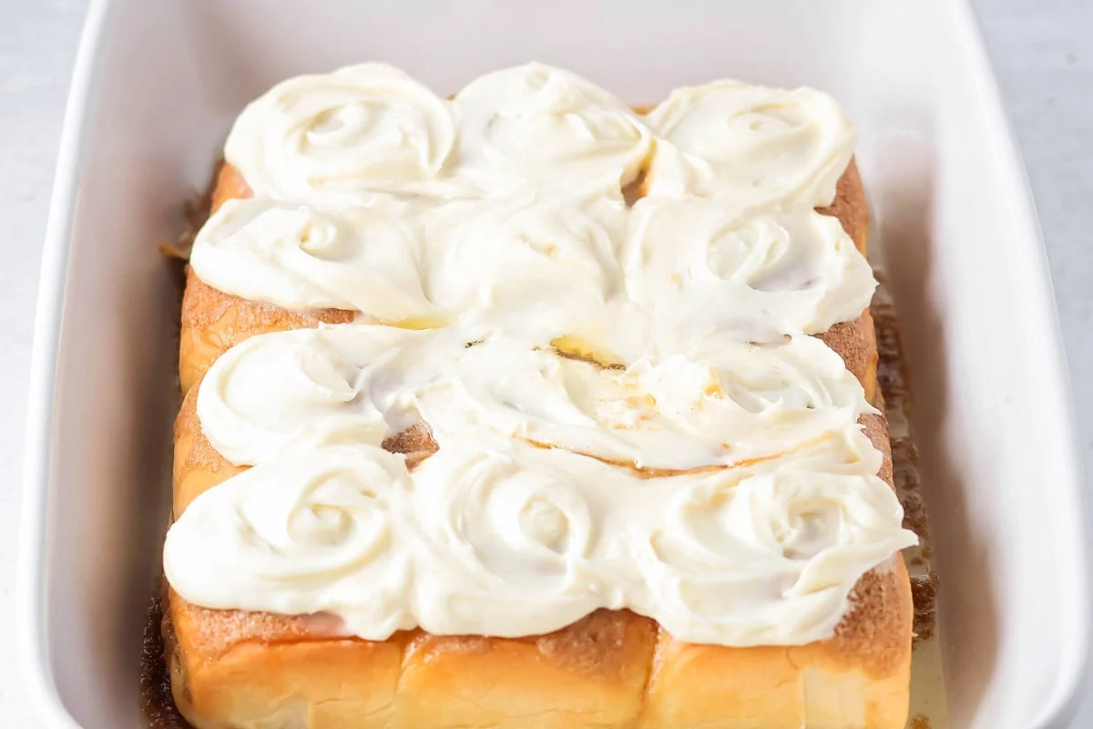 Frosting spread on Hawaiian King cinnamon rolls.