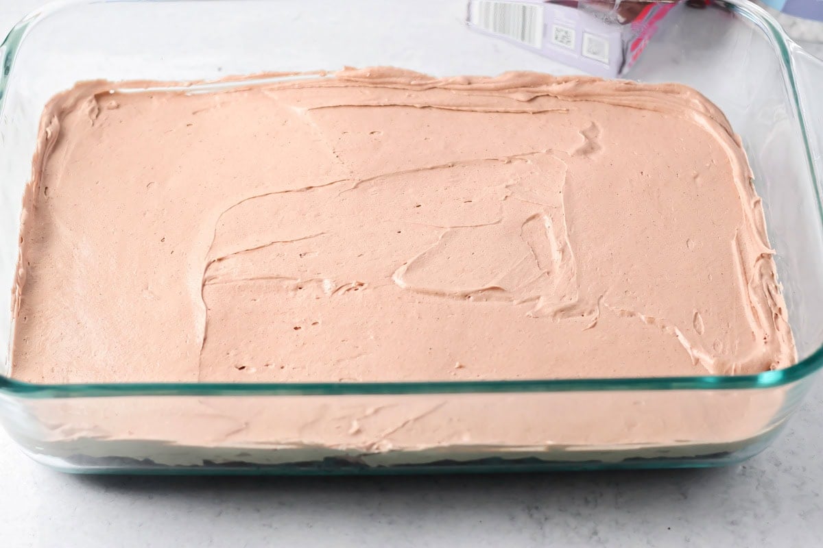 Spreading a chocolate layer on hot chocolate lasagna.