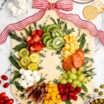 Christmas charcuterie board filled with fruits, veggies, cheese and meat.