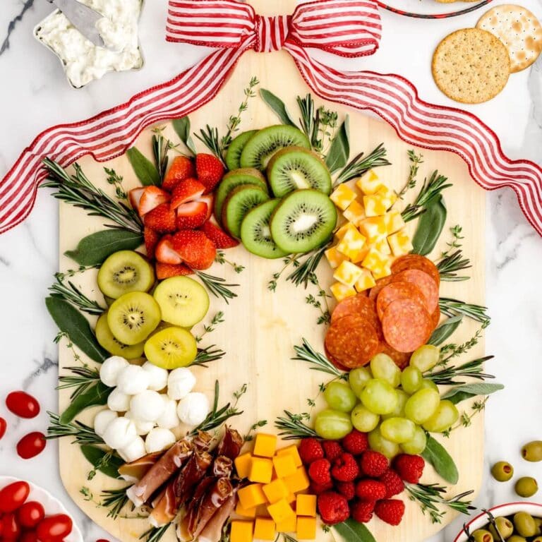 Christmas charcuterie board filled with fruits, veggies, cheese and meat.